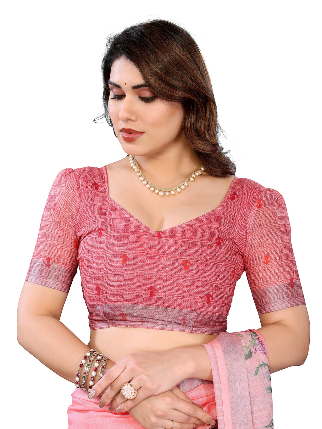NxWear Fashion peach linen saree with floral print border, worn by a model with pearl necklace and bangles.
