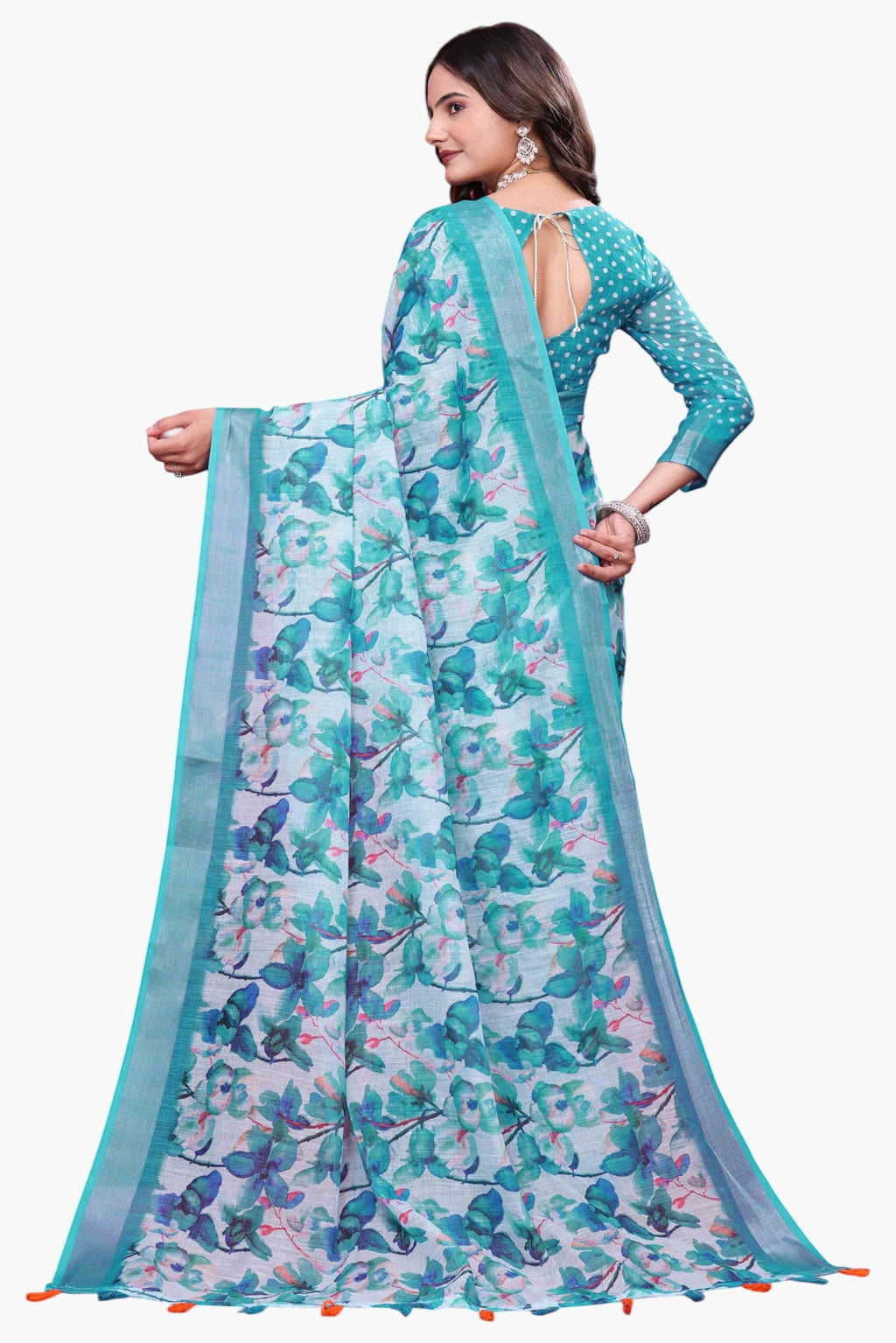 NxWear Fashion teal linen saree with a delicate floral print and a contrast teal border. Model wears a matching polka dot blouse.