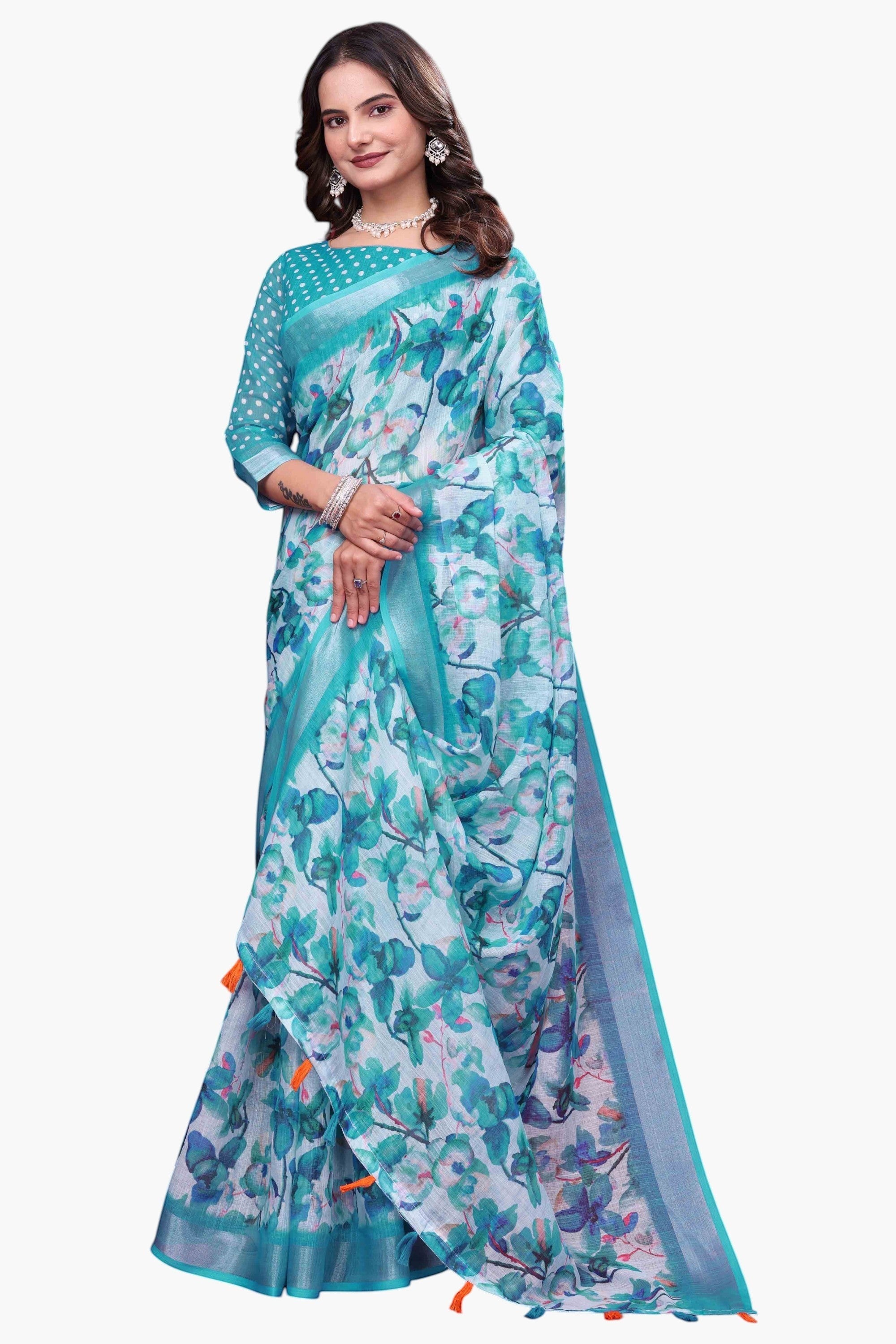 NxWear Fashion teal linen saree with a delicate floral print and contrast border. Model wears a matching polka dot blouse.