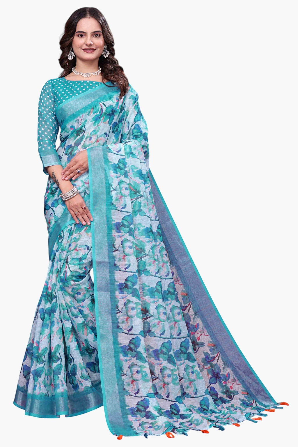 NxWear Fashion teal linen saree with a white base and vibrant blue and green floral print. Features a contrasting teal border and tassels.